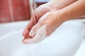 Cleaning soapy hands with running water