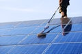 Cleaning solar panels with brush and water