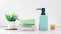 Cleaning sponge on plates with dish soap bottle and washing brushes on white marble kitchen table Royalty Free Stock Photo