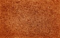 Cleaning sponge rubbing surface close up with blur effect in orange color Royalty Free Stock Photo