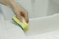 Cleaning with sponge scouring pad closeup