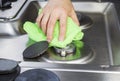 Cleaning stove top with microfiber cloth Royalty Free Stock Photo