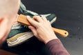 Cleaning suede sneakers. A worker in a shoe workshop cleans a pile of shoes Royalty Free Stock Photo