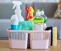 Cleaning supplies, brush and basket tools on table in home living room for hygiene. Cleaning products, spring cleaning