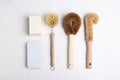 Cleaning supplies for dish washing on white wooden table, flat lay Royalty Free Stock Photo