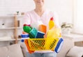 Senior woman holding basket with lots of detergents Royalty Free Stock Photo