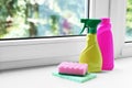 Cleaning supplies and sponges on window sill indoors, space for text