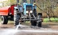 Cleaning sweeper tractor pours water