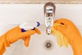 Cleaning tap from limescale bathroom sink close-up Royalty Free Stock Photo