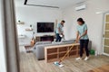 Cleaning team. Two professional cleaners in uniform working together in the living room. Young afro american woman Royalty Free Stock Photo