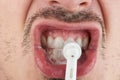 Cleaning teeth with electrical brush Royalty Free Stock Photo