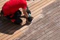 Cleaning the terrace with power sander, wood boards before and after sanding