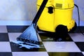 Cleaning tile floor surface foam with a wet vacuum, sanitary restoring clean of debris. Maintaining a safe hygiene of cleanliness