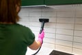 Cleaning tiles with steam machine.