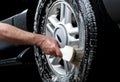 Cleaning tire in a car wash Royalty Free Stock Photo