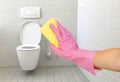 Hands in pink gloves clean the toilet Royalty Free Stock Photo