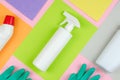 Cleaning tools company concept. White bottles with detergents and cleaning products and a sponge on a colored background Royalty Free Stock Photo