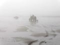 Cleaning tractor in foggy weather on the beach of Sainte CÃ©cile Plage in Picardie Royalty Free Stock Photo