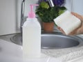 The cleaning transparent gel-like product for washing hands and dishes in focus. Biodegradable plastic and environmentally