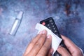 Cleaning Tv remote control with an antibacterial fabric tissue..