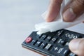 Cleaning Tv remote control with an antibacterial fabric tissue..