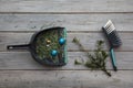 Cleaning up after christmas. Sweeping up pine needles and broken decorations Royalty Free Stock Photo