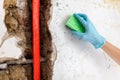 Cleaning up dangerous fungus from a wet wall after water pipe leak Royalty Free Stock Photo