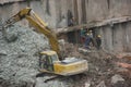 Are cleaning up the dirt of the excavator at the SHENZHEN construction site