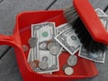 Cleaning up and sweeping up money with a dustpan and broom Royalty Free Stock Photo