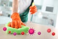 Cleaning vs viruses. Woman washing table with sponge and disinfecting solution