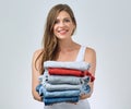 Cleaning and washing concept with woman holding stack clothes