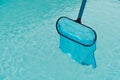 Cleaning the water surface of an outdoor pool Royalty Free Stock Photo