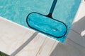 Cleaning the water surface of an outdoor pool with Royalty Free Stock Photo