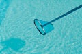 Cleaning the water surface of an outdoor pool Royalty Free Stock Photo