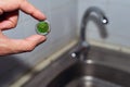 Cleaning the water tap. The male hand holds a clogged aerator. Sediment in water