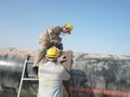 Cleaning of welding seams on the pipeline the grinder.