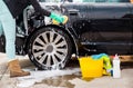 Cleaning the wheel car wash with a sponge Royalty Free Stock Photo