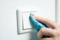 Cleaning A White Light Switch On A Wall With Wipe Royalty Free Stock Photo