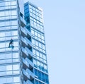 Handyman while cleaning the window of a building outside Royalty Free Stock Photo