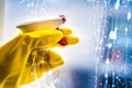 Cleaning window with squeegee with blue sky . Hand in yellow glove Royalty Free Stock Photo