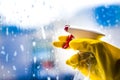 Cleaning window with squeegee with blue sky . Hand in yellow glove. Royalty Free Stock Photo