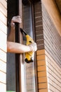 Cleaning window using portable vacuum windows cleaner. Washer of cleaning service cleans outside of the window to remove