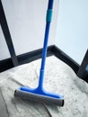 Cleaning windows with a blue squeegee during spring cleaning Royalty Free Stock Photo