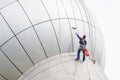 Cleaning windows service on high rise building. it is dangerous Royalty Free Stock Photo