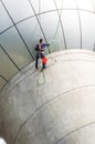 Cleaning windows service on high rise building. it is dangerous Royalty Free Stock Photo