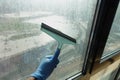 Cleaning windows with a squeegee. Royalty Free Stock Photo