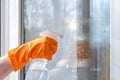 Cleaning windows using cleaning products. Royalty Free Stock Photo