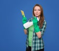 Cleaning woman with cleaning spray bottle happy and smiling. Beautiful cleaning girl isolated on blue background with c Royalty Free Stock Photo