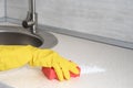 Deep Cleaning service. woman gloves hands cleaning kitchen table with red sponge. Surface sanitizing. Home cleaning and Royalty Free Stock Photo