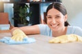 Cleaning, woman or portrait happy cleaner with cloth and gloves for dusty, messy or dirty bacteria on wooden table Royalty Free Stock Photo